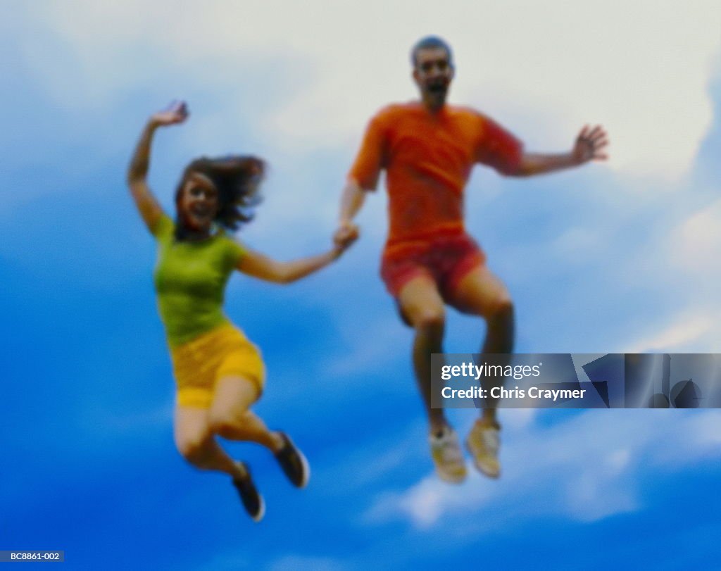 Couple leaping, holding hands (Digital Enhancement)
