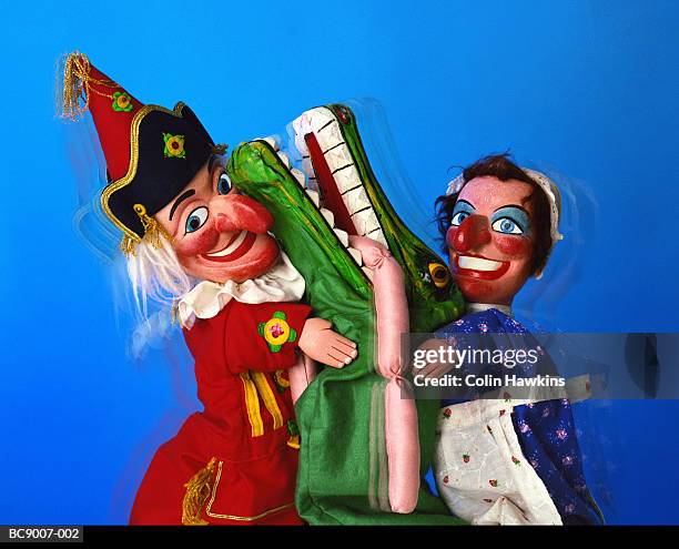 punch and judy puppets with crocodile character eating sausages - puppet show stock pictures, royalty-free photos & images