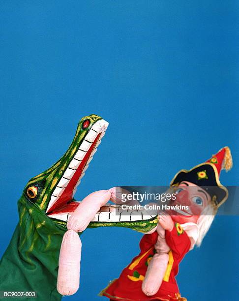punch puppet wrestling with crocodile character, close-up - puppentheater stock-fotos und bilder