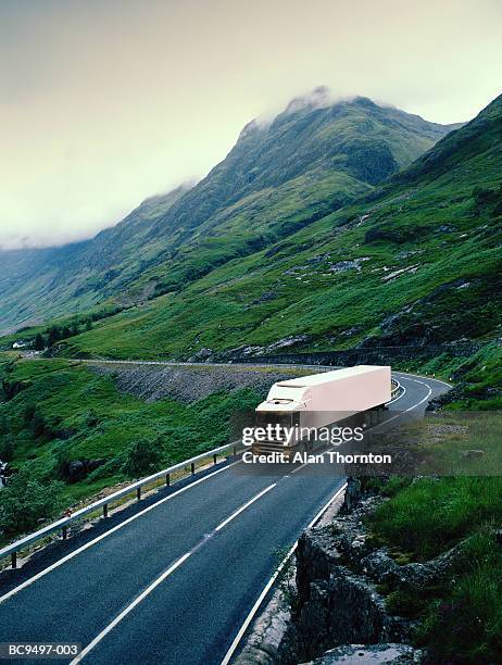 white lorry on road through rural landscape (digital enhancement) - lorry uk stock-fotos und bilder