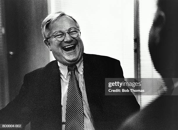 mature male executive sitting opposite colleague, laughing (b&w) - male portrait suit and tie stock-fotos und bilder