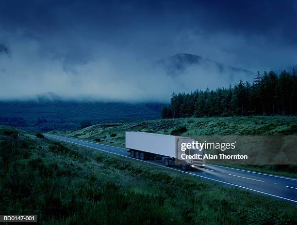 white lorry driving along country road at night (digital enhancement) - transport logistique photos et images de collection