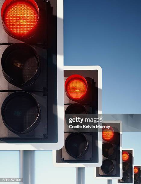 row of traffic lights, red lights illuminated (digital composite) - rood stoplicht stoplicht stockfoto's en -beelden