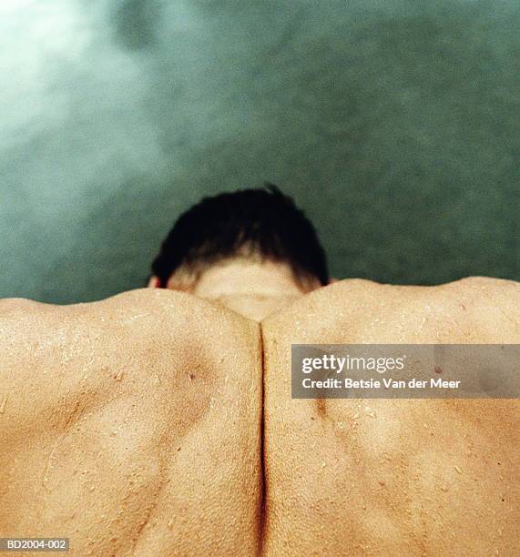 man's clenched shoulders, close-up, elevated view - goosebumps stock pictures, royalty-free photos & images