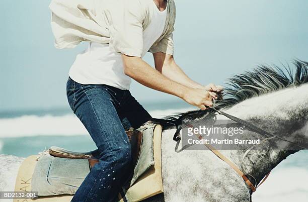 man riding horse on beach, close-up - animal riding stockfoto's en -beelden