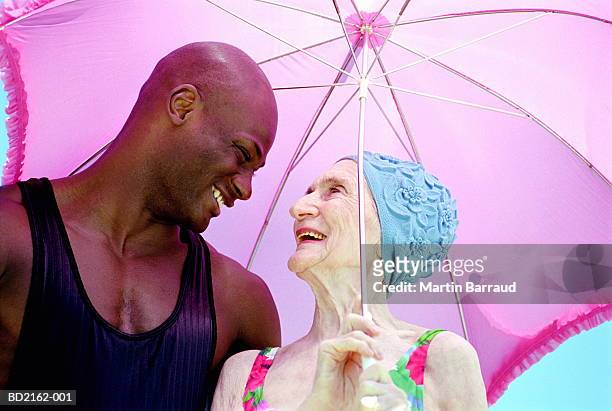 elderly woman and young man smiling, close-up - extreme close up stock-fotos und bilder