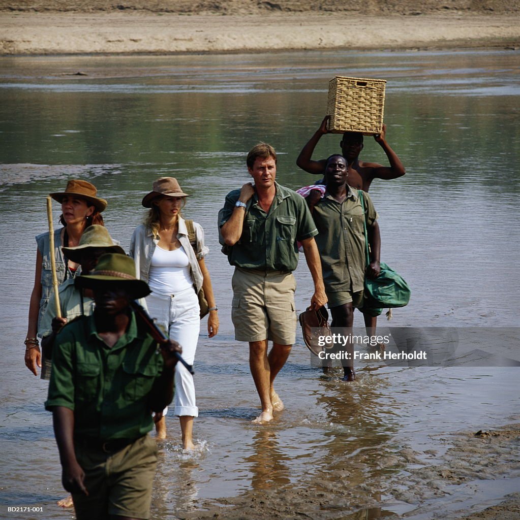 Zambia, South Luangwa National Park, safari group crossing river