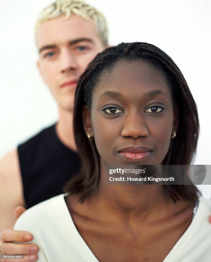 Young couple, man behind woman, portrait (focus on woman)