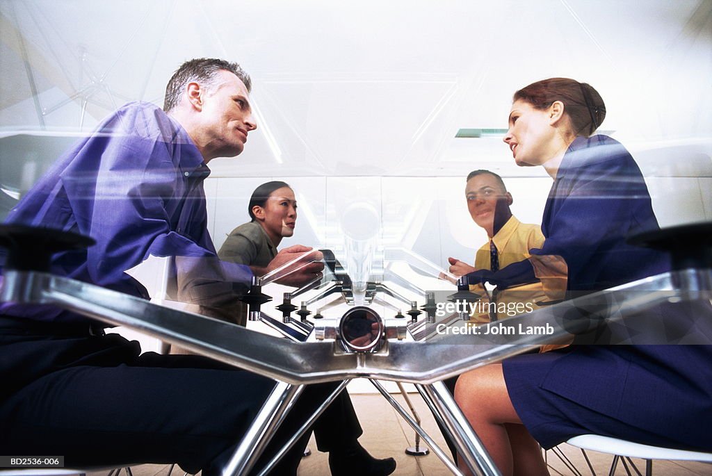 Business executives sitting at conference table, low angle view