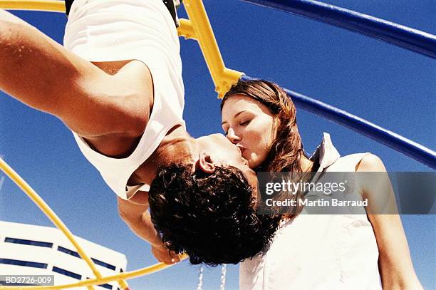 young couple kissing, outdoors, close-up - kussen stockfoto's en -beelden