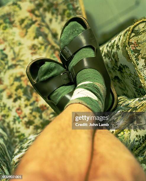 young man's feet wearing socks and sandles, legs crossed at ankles - feet up stock pictures, royalty-free photos & images