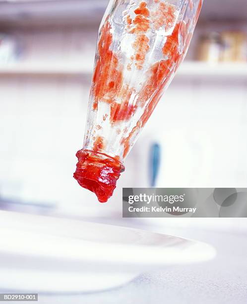 empty tomato ketchup bottle - tomatenketchup stockfoto's en -beelden