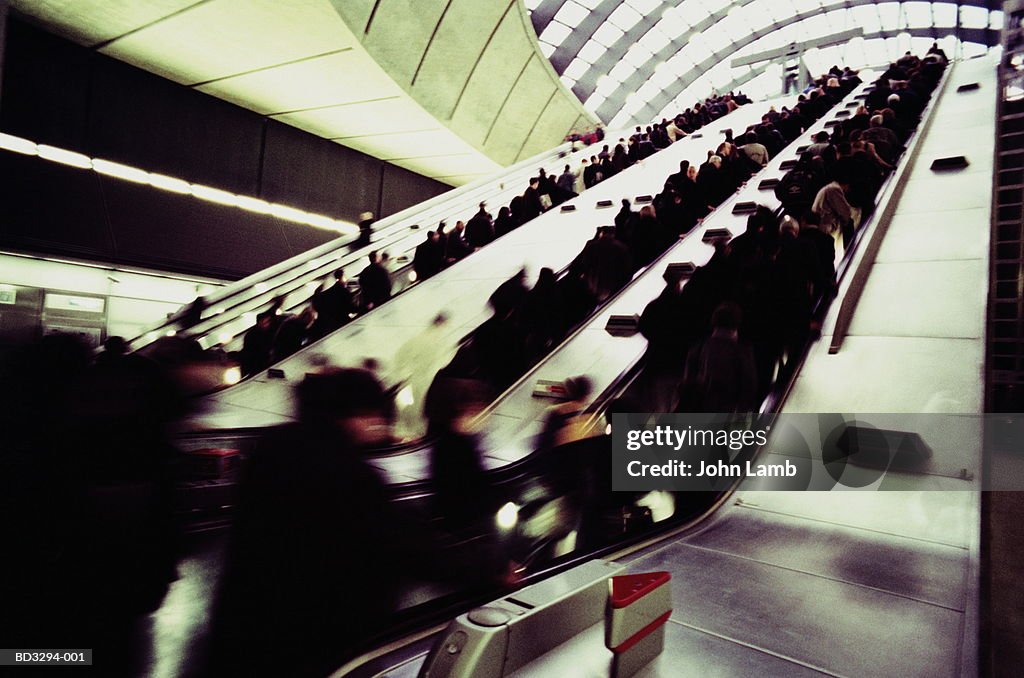 Passengers on underground station escalators (blurred motion)