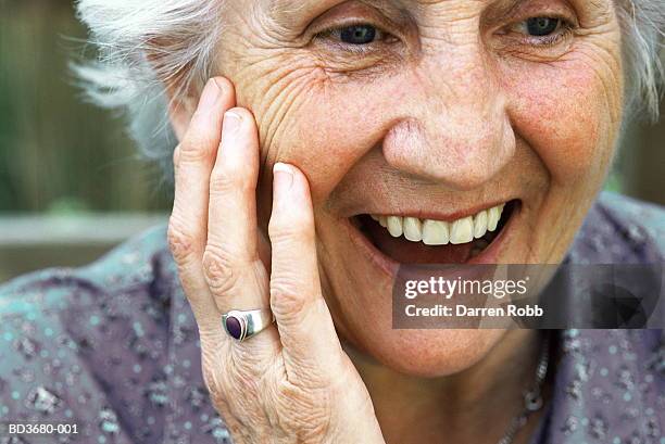 elderly woman smiling, close-up - überraschung stock-fotos und bilder