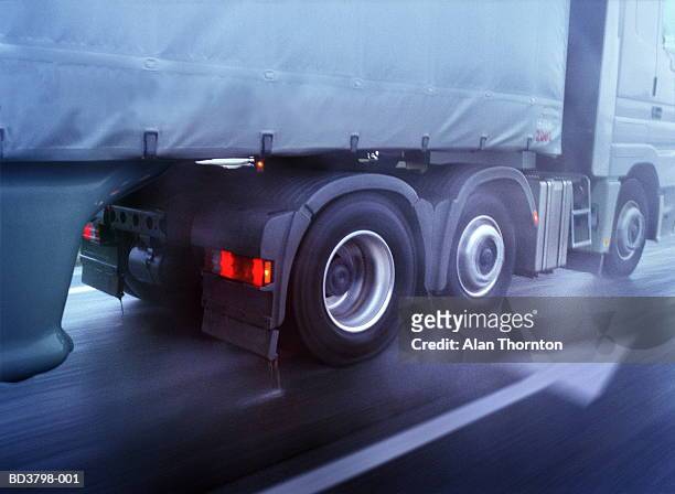 lorry driving on wet road, low section, close-up (blurred motion) - mezzo di trasporto foto e immagini stock