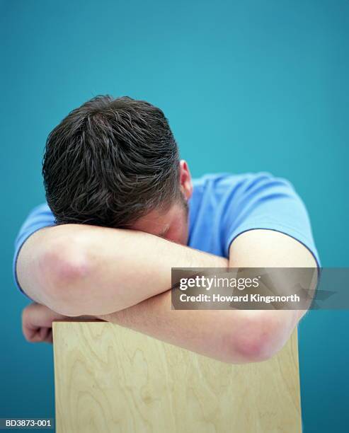 teenage boy (16-18 years) with head resting on arms, close-up - 18 19 years photos stock pictures, royalty-free photos & images