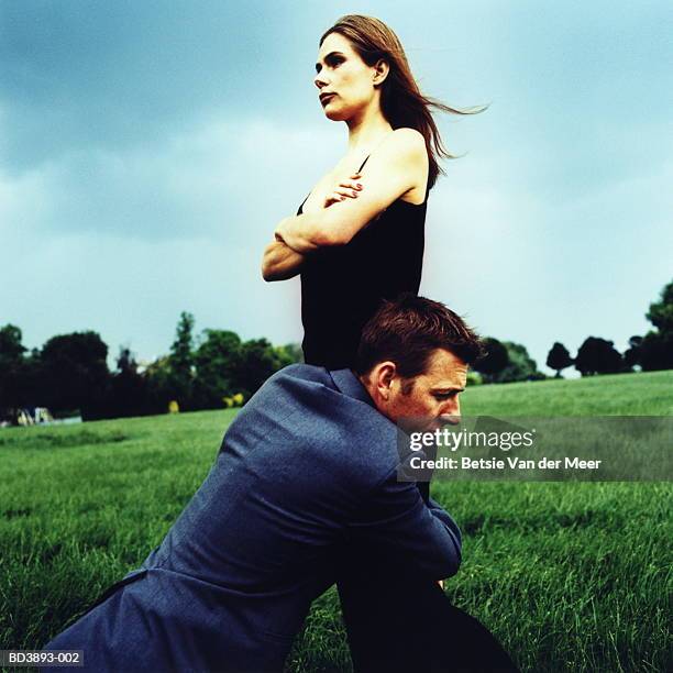 couple in field, man hugging woman's legs - redemption stock pictures, royalty-free photos & images