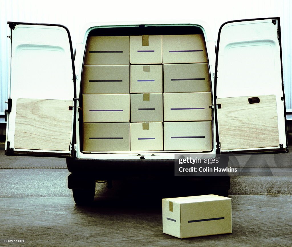 Stationary van loaded with boxes, doors open, rear view