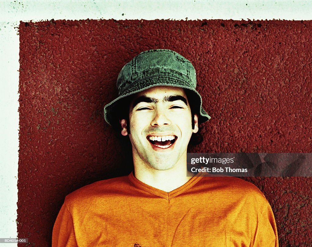 Young man laughing, close-up