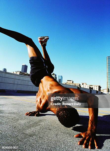 young man break-dancing in rooftop car park, close-up - breakdancing stock pictures, royalty-free photos & images