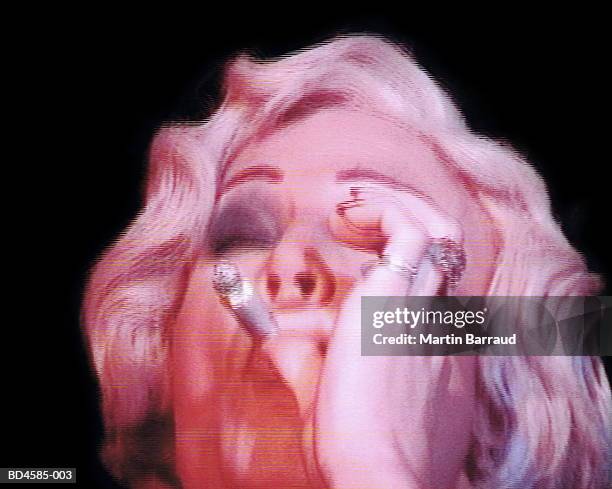 transvestite smoking 'joint', close-up (video still) - spinello foto e immagini stock