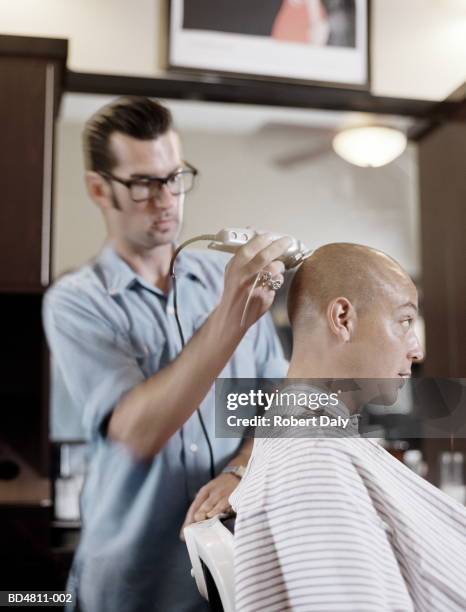 young man having his head shaved by barber - electric razor stock pictures, royalty-free photos & images