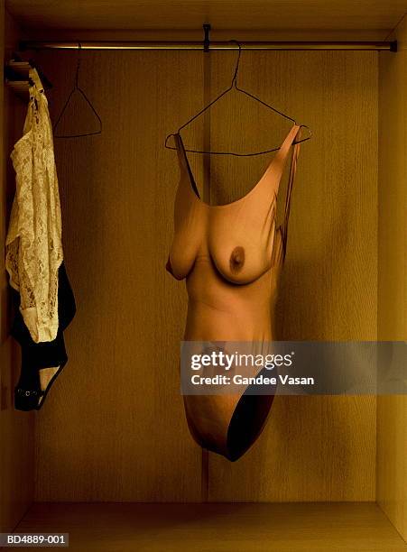 female body on hanger in cupboard (digital enhancement) - eendelig zwempak stockfoto's en -beelden