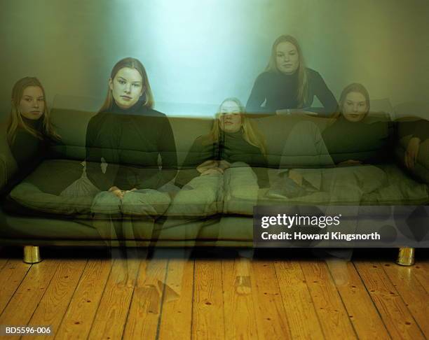 young woman in varied positions on sofa (digital composite) - cloning stock-fotos und bilder