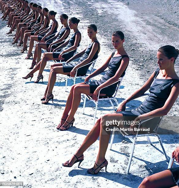 cloned woman sitting in row (digital composite) - cloning stock-fotos und bilder