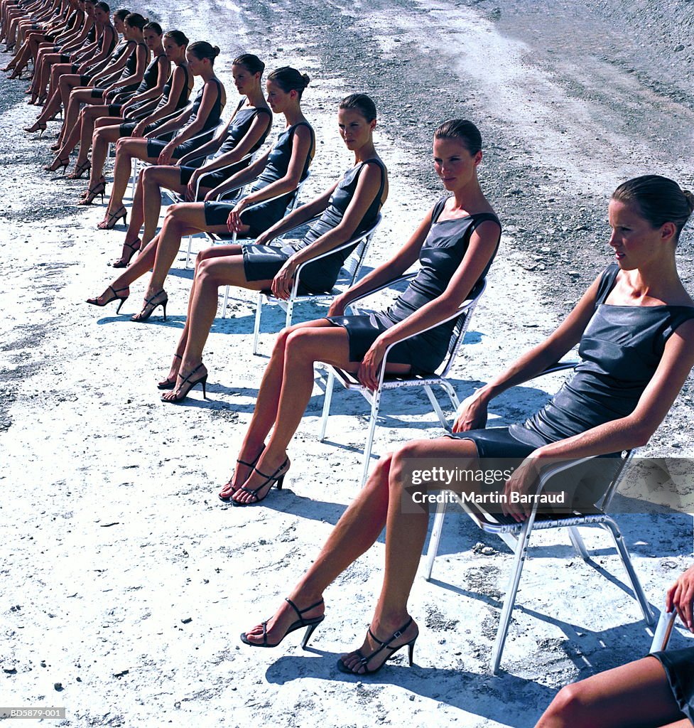 Cloned woman sitting in row (Digital Composite)