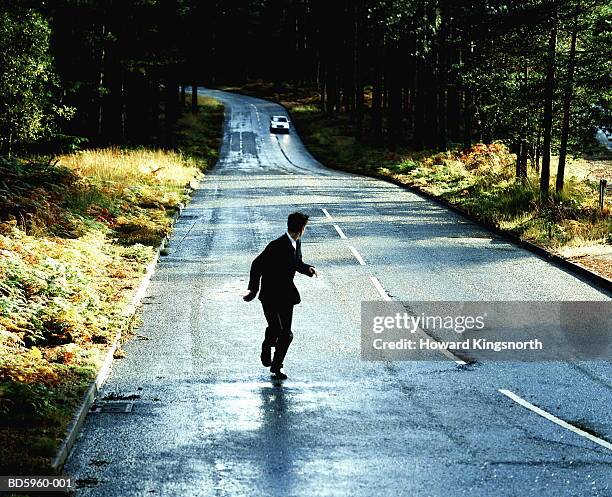 businessman being chased by car - people chasing stock pictures, royalty-free photos & images