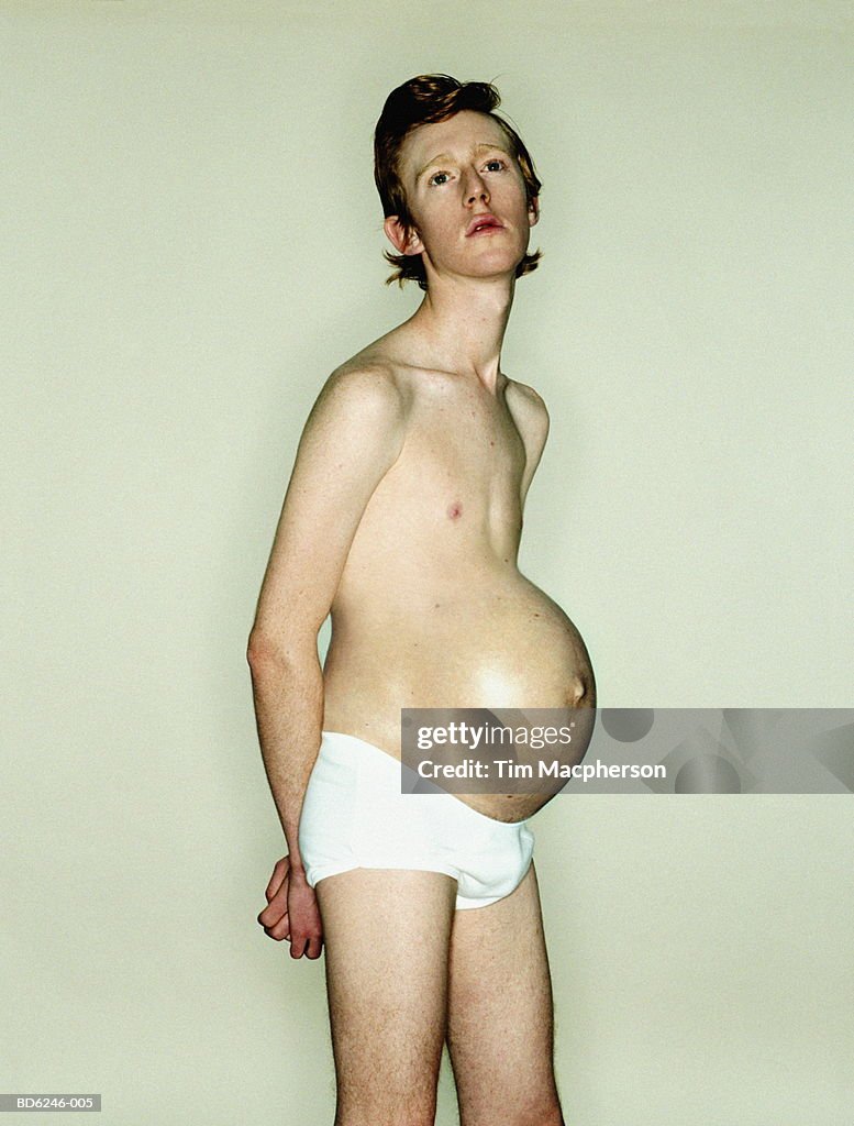 Young man with pregnant woman's stomach (Digital Composite)