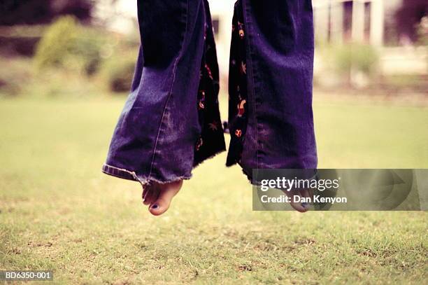 teenage girl (12-14) jumping, close-up, low section - flared trousers stock pictures, royalty-free photos & images