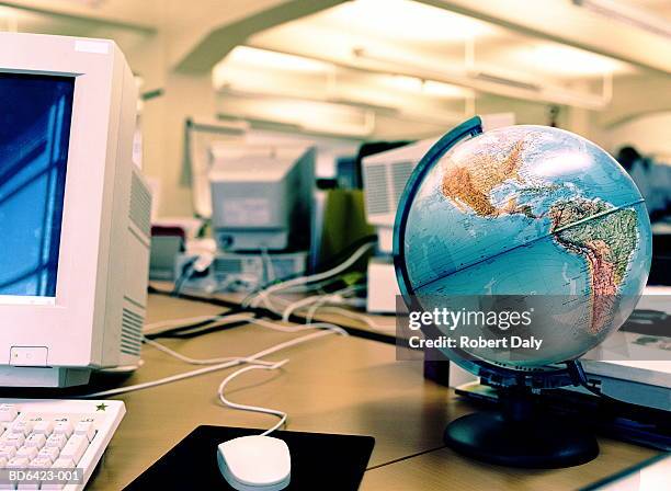 globe on desk in office - desktop globe stock-fotos und bilder