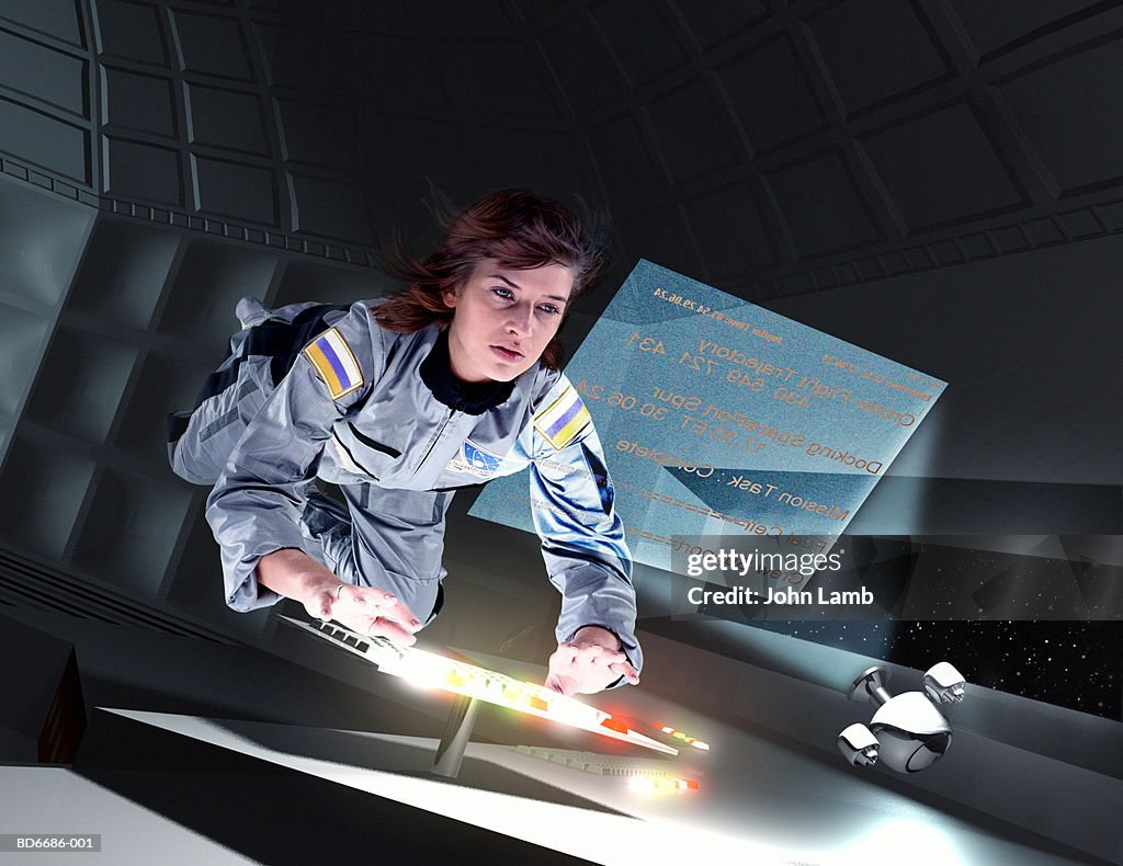 Female astronaut floating in space station (Digital Composite)