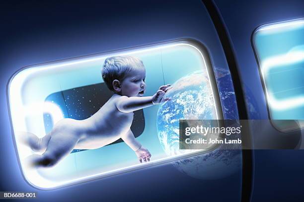 baby (15-18 months) floating in space station (digital composite) - space station stock pictures, royalty-free photos & images