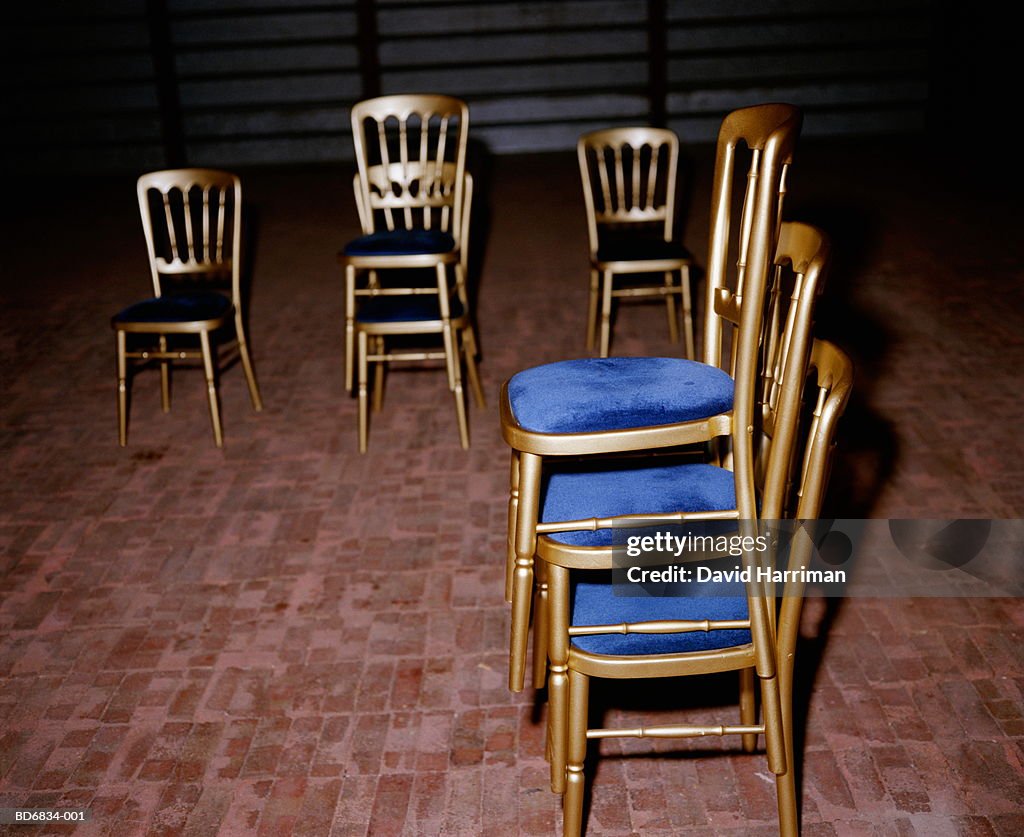 Stacks of gold coloured chairs