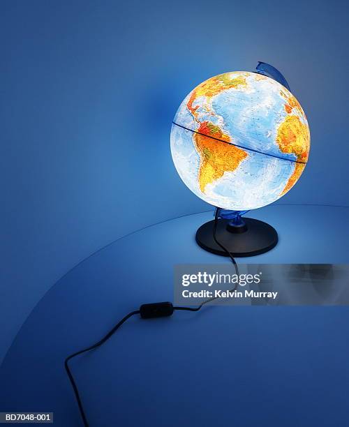 illuminated globe on curved background - globo terrestre de escritório imagens e fotografias de stock