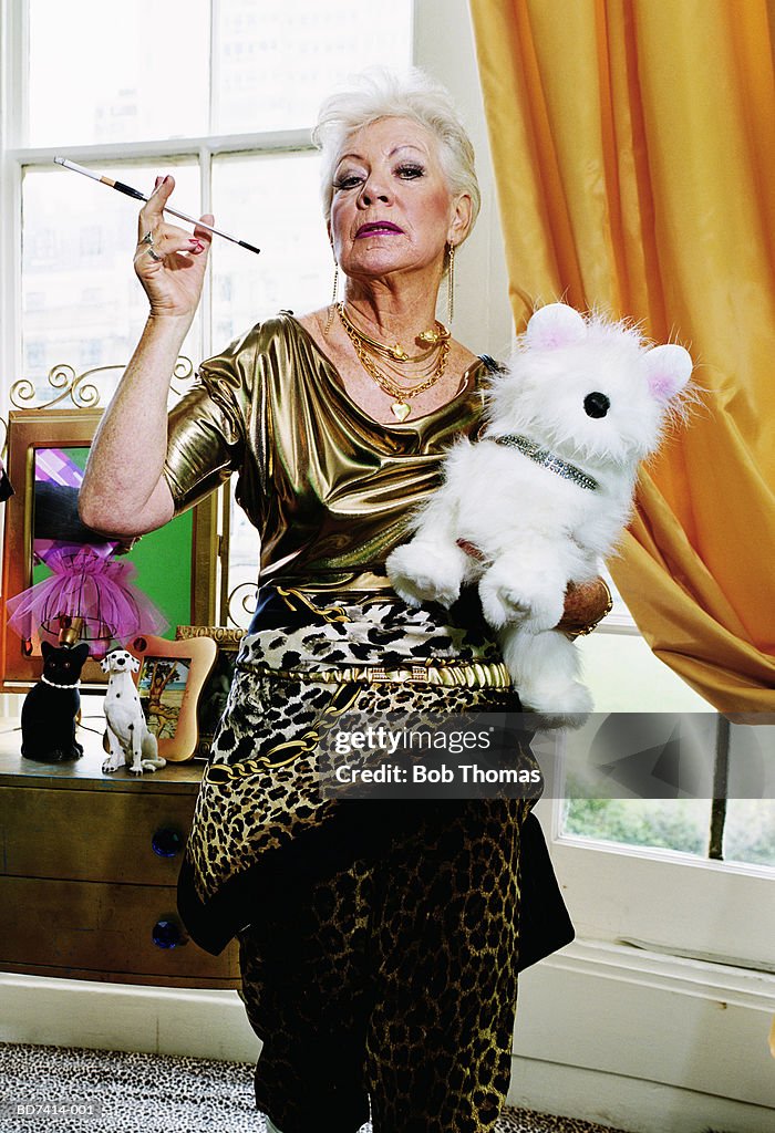 Elderly woman with cigarette holder and toy dog, portrait