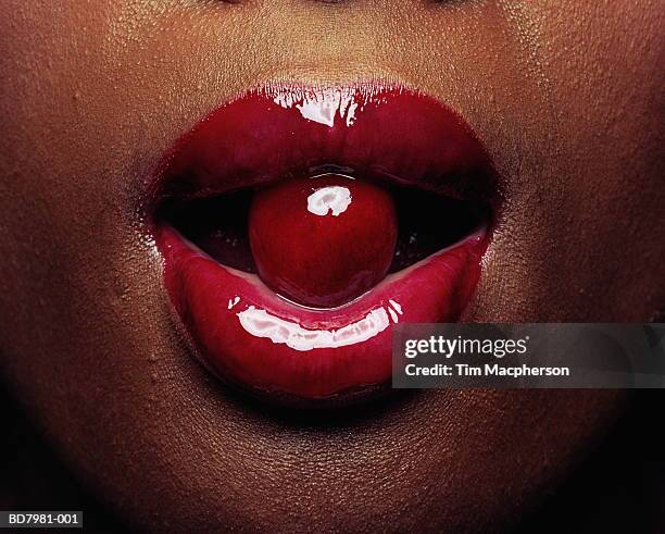woman, cherry between lips, detail - black cherries stock pictures, royalty-free photos & images