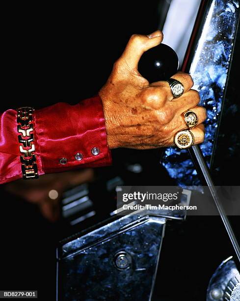 elderly man pulling handle of fruit machine, close-up - handle stock pictures, royalty-free photos & images