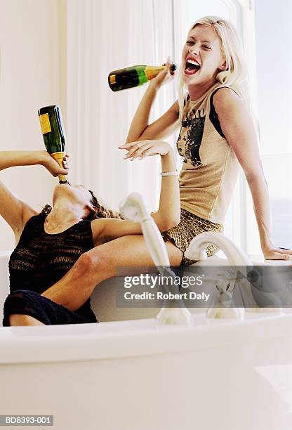 two young women drinking champagne in hot tub - hot tub party stock pictures, royalty-free photos & images