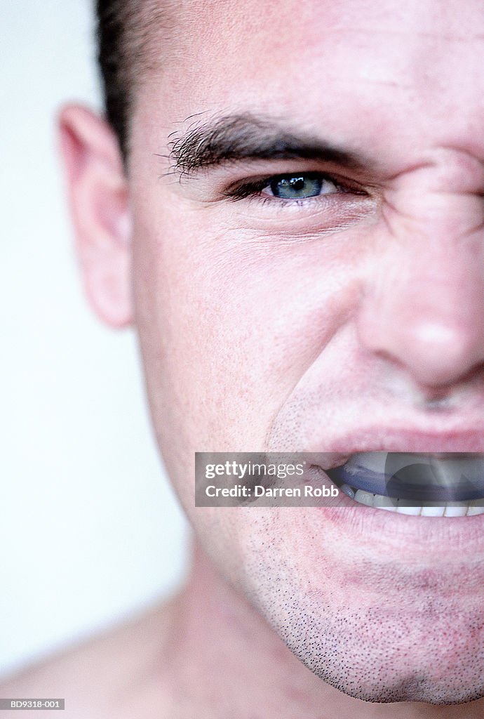 Man with gum shield in mouth, close-up