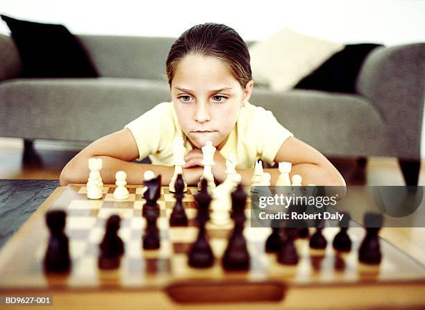 girl (9-11) looking at chess board, close-up - playing chess stock-fotos und bilder