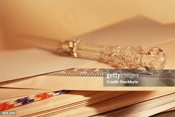 letter opener with crystal handle resting on envelopes - abrecartas fotografías e imágenes de stock