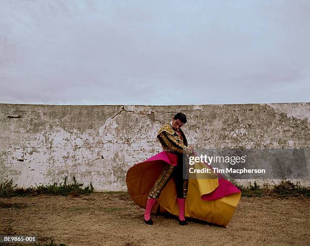 matador swinging cloak in arena, portrait - bullfighter stock pictures, royalty-free photos & images