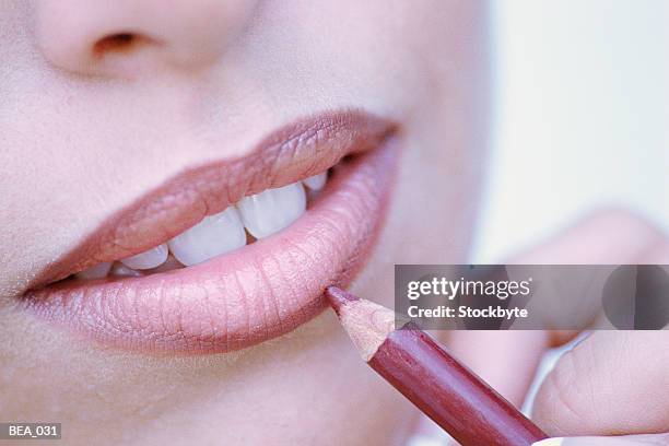 close-up of woman applying lip liner - lip liner stock pictures, royalty-free photos & images