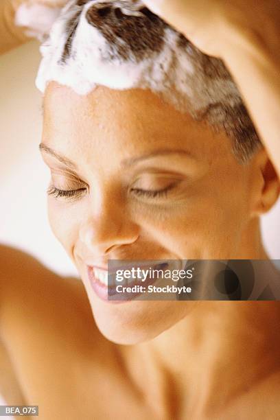 woman shampooing hair - haar wassen stockfoto's en -beelden