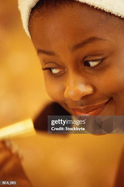 woman applying blush with brush - blusher brush stock pictures, royalty-free photos & images