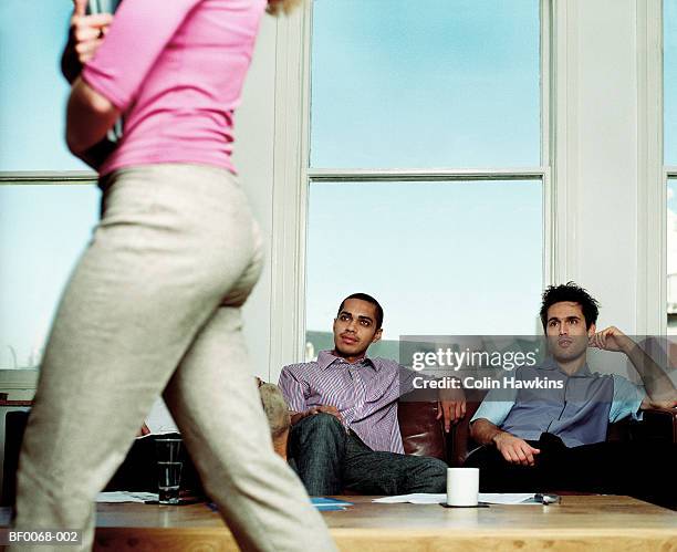three men watching woman walk past - discriminazione sessuale foto e immagini stock